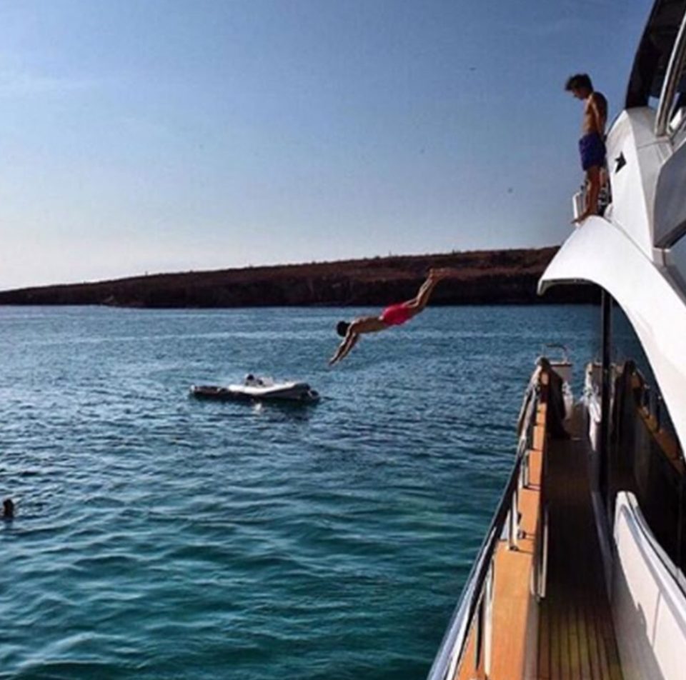  A reveller dives off his swanky yacht