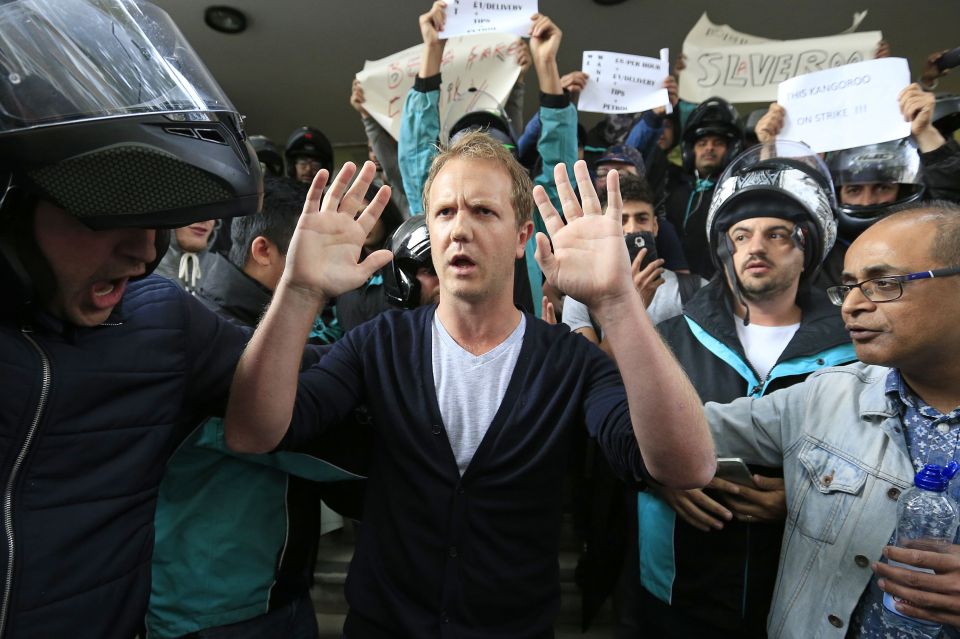  The manager tries to address protesters outside the company's central London headquarters