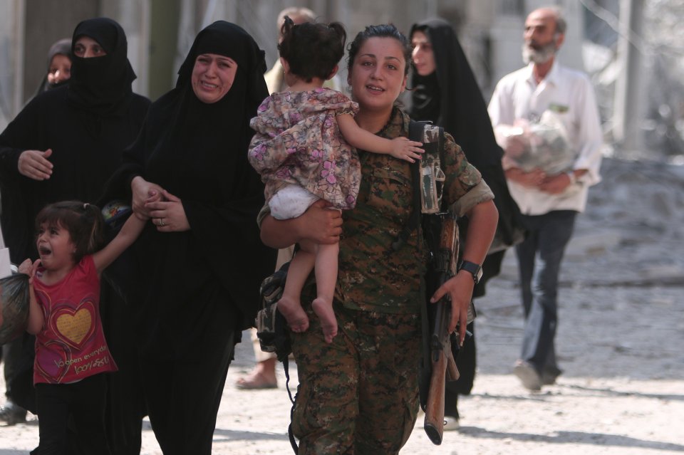  Helping hand . . . soldier carries tot down street