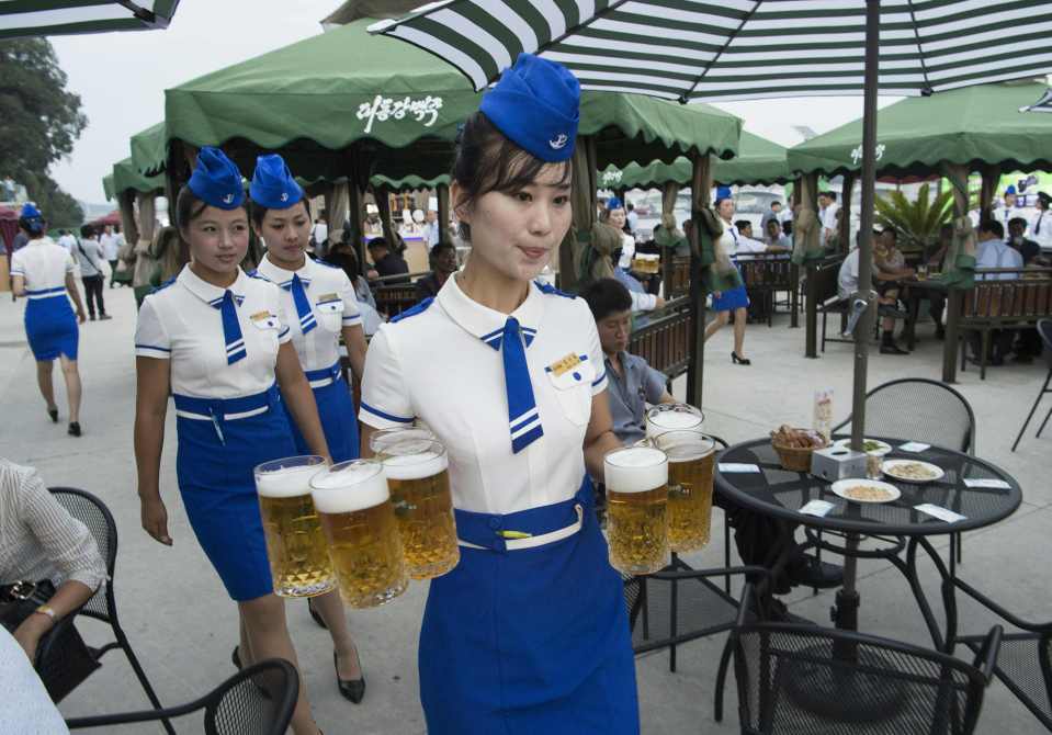  Smartly-dressed waitresses served beer to tourists and North Korean elites at the bizarre festival