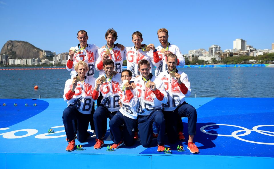  Golden boys . . . men's eight pose by rowing lake with medals