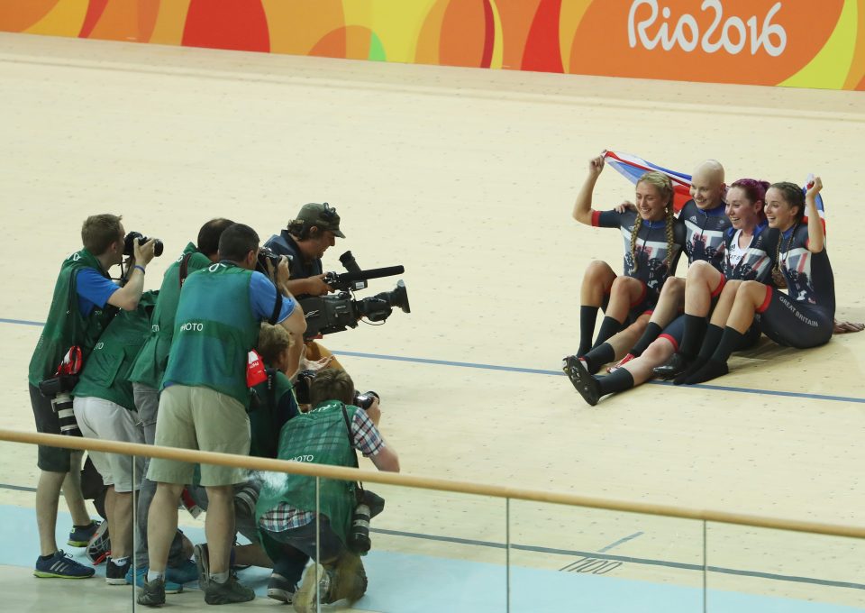  The quartet celebrate their medal in front of the cameras