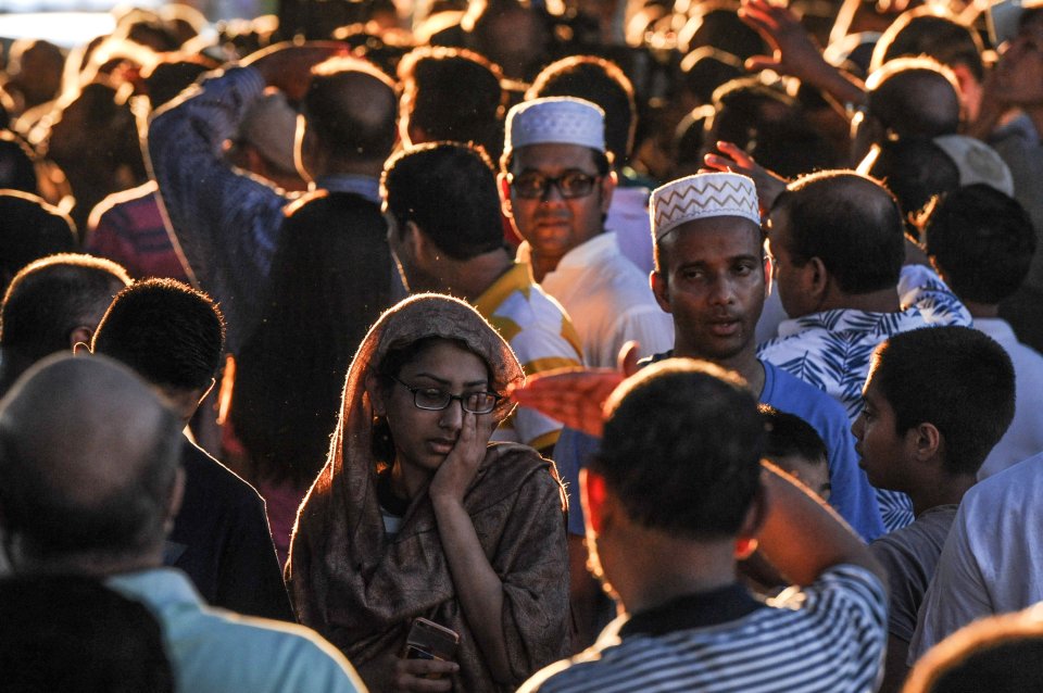  A crowd of community members gather at the place where Imam Maulama Akonjee was killed in the Queens borough of New York