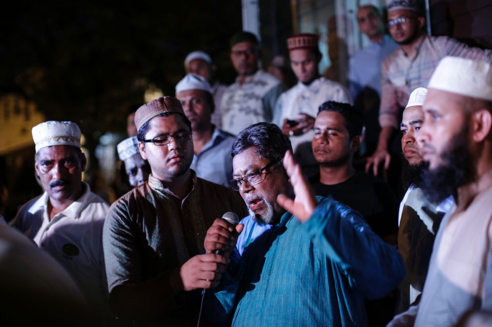  Community members pray outside the Al-Furqan Jame Mosque in Ozone Park after the shooting, with many saying it was a hate crime