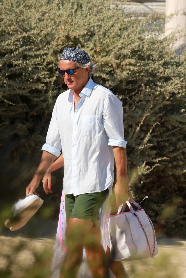  Former Man City boss Roberto Mancini was sporting some questionable headwear