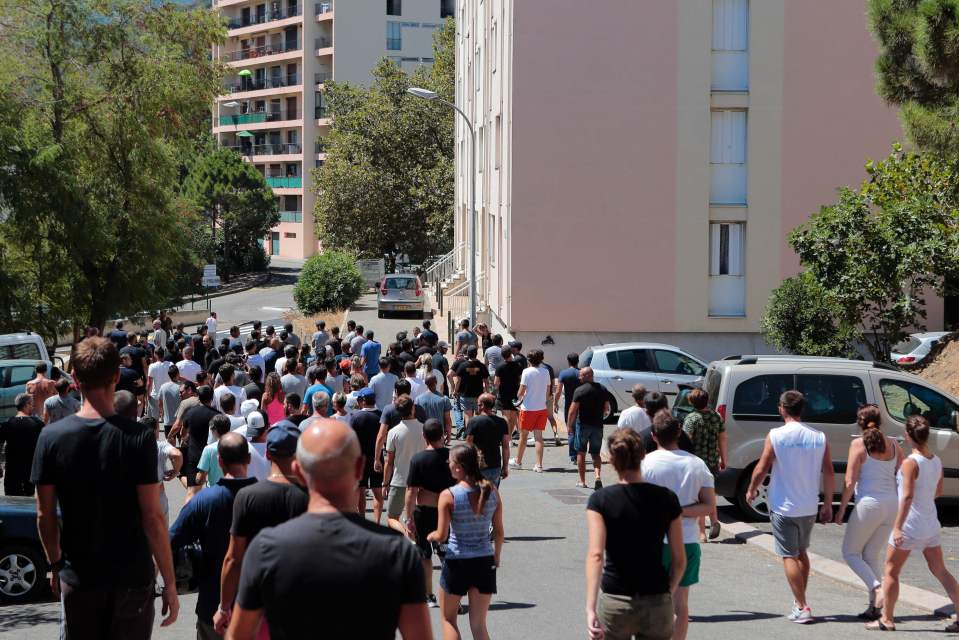 Hundreds gather in the city of Bastia yesterday a day after a violent clash between locals and immigrants