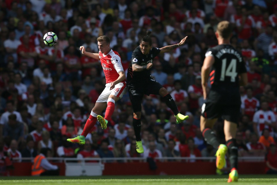  Holding competes for the ball with Liverpool's Roberto Firmino during the Premier League match against at the Emirates Stadium in London