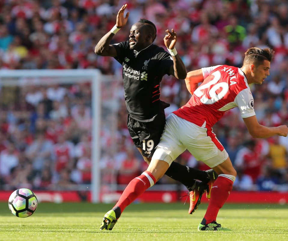 Xhaka (R) challenges Liverpool's Senegalese midfielder Sadio Mane