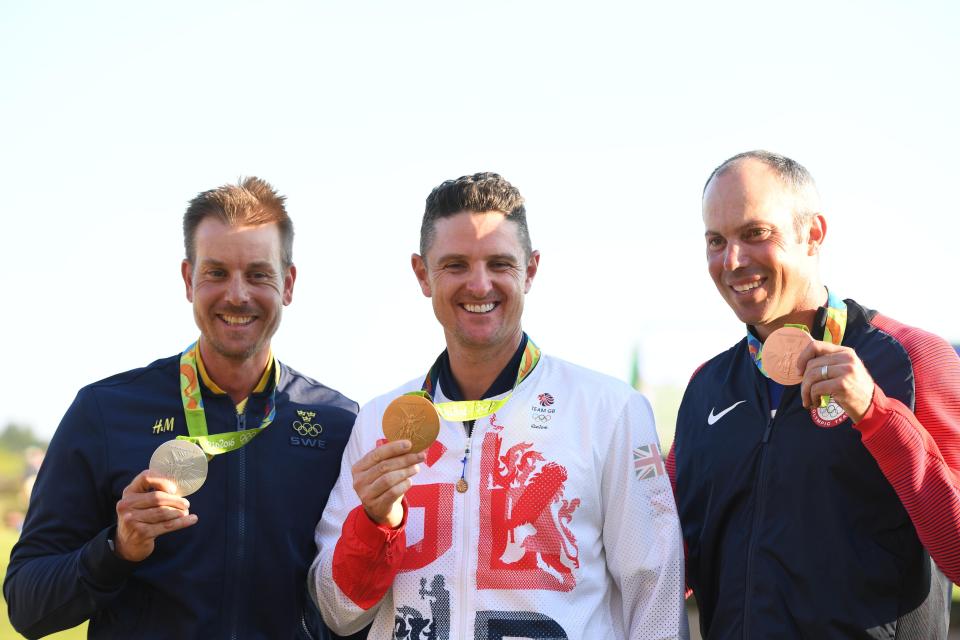  Champ poses with fellow medallists Henrik Stenson and Matt Kuchar