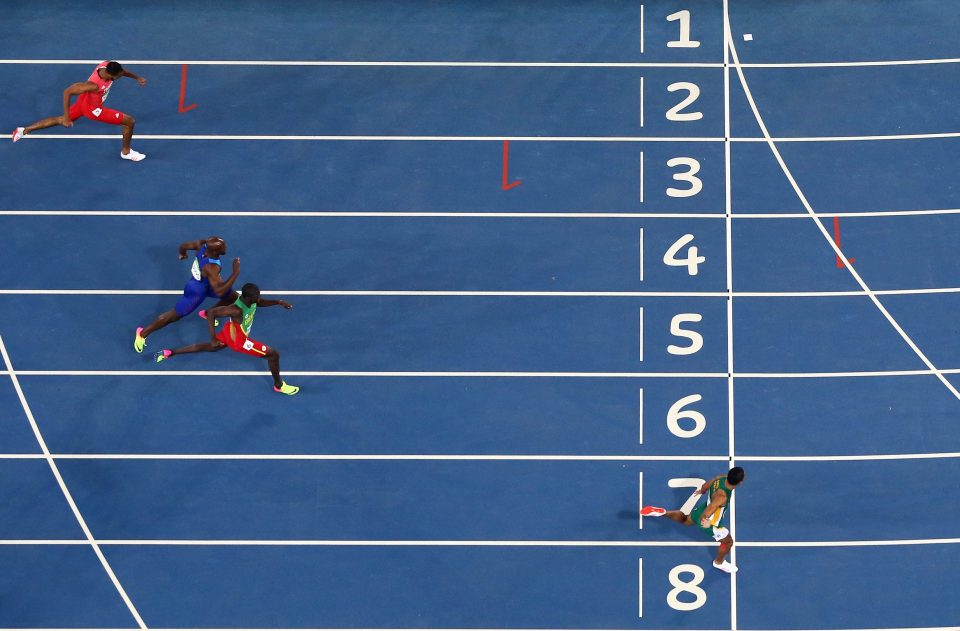  Wayde van Niekerk crosses the line in first place and miles ahead of his 400m rivals