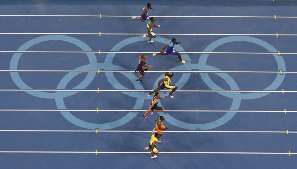  The eight sprinters move along the home straight in the Olympic 100 metres final