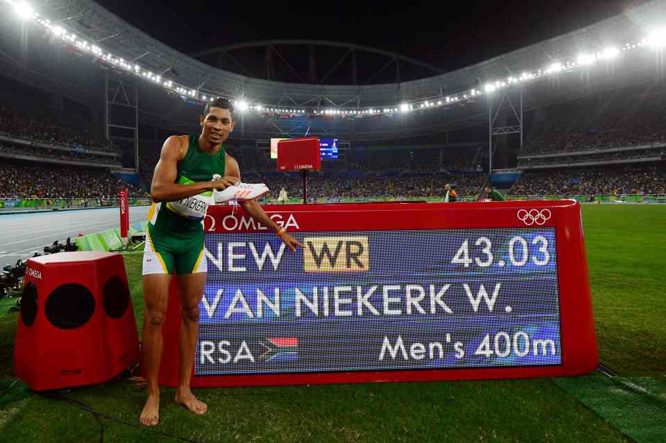  Van Niekerk points to his new world record time shortly after the stunning race