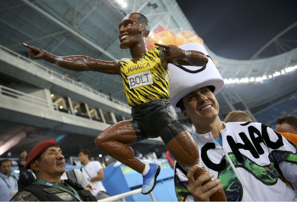  A fan of the Jamaican sprinter carries a doll of the Olympic champ