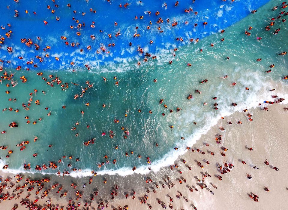  The shot from above reveals the vast numbers of people clamouring for space on the sand