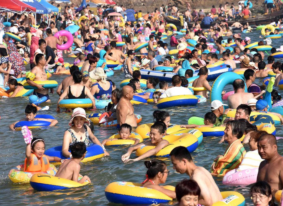  Dozens of beachgoers floated in the refreshing water on lilos