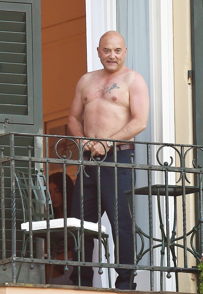  A bare chested Gregg Wallace appears on his balcony doing his belt up and looking very pleased with himself