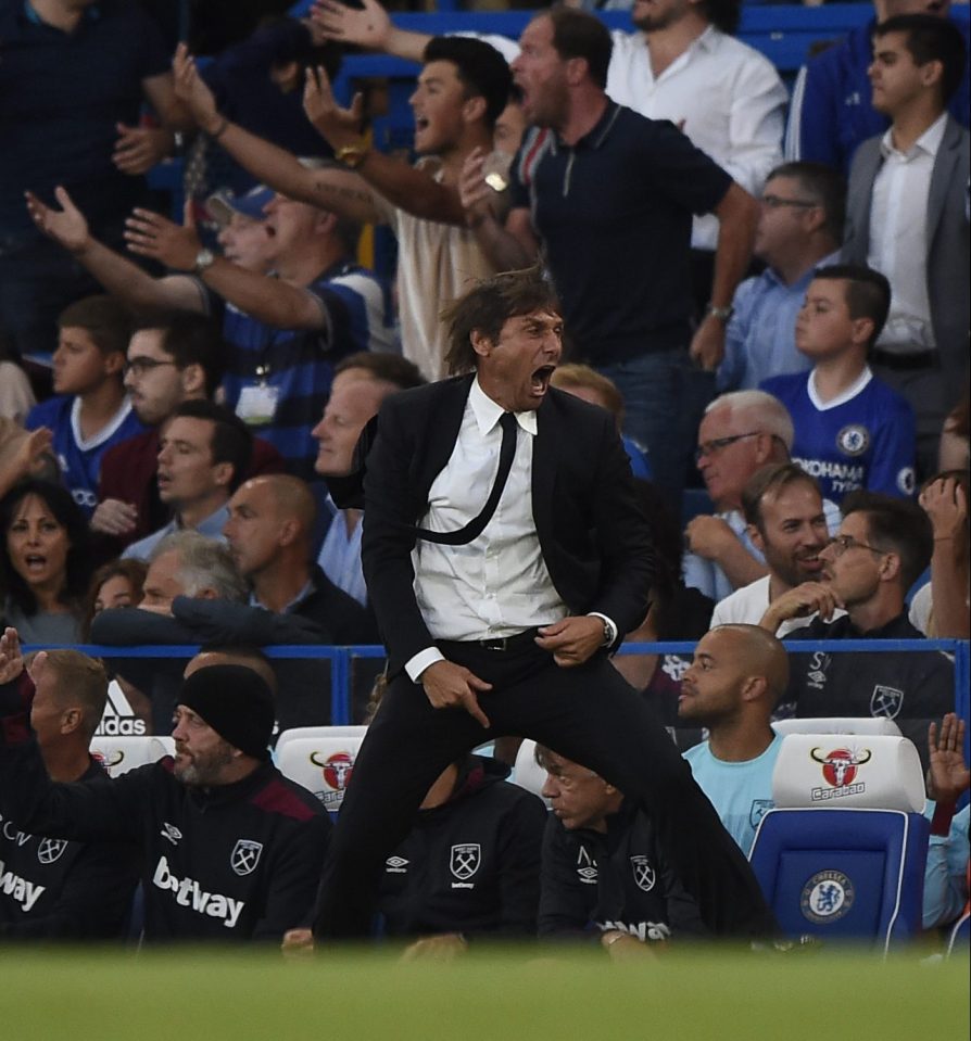  Antonio Conte's tie flaps about as he charges around the technical area