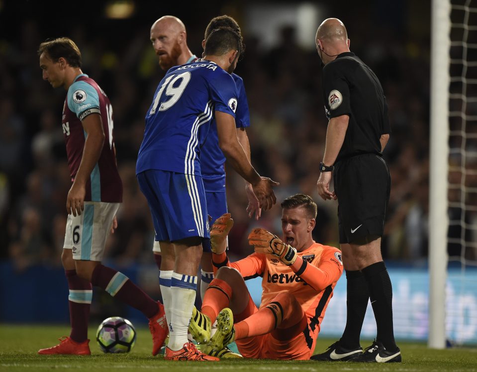  Adrian is helped to his feet after a rash challenge