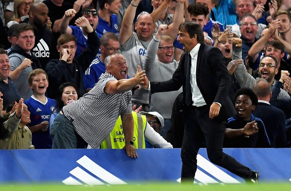  Conte high fives a fan on the touchline