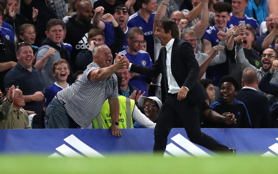  Chelsea manager Antonio Conte high-fives the fans after the Blues score their winner