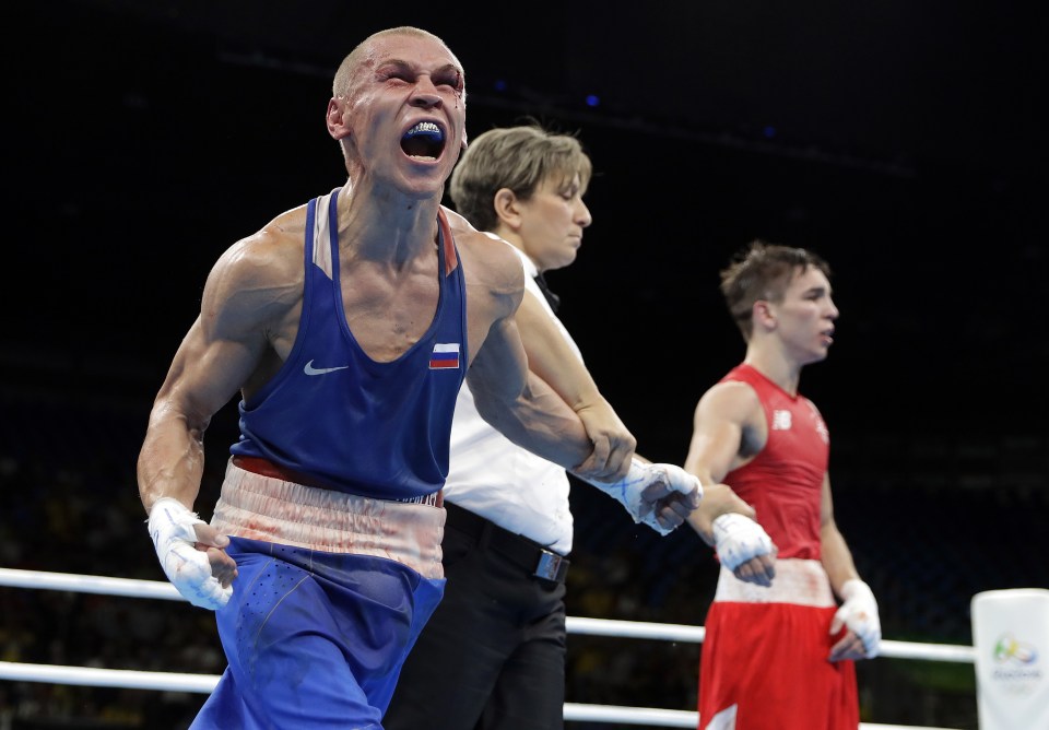 Russia's Vladimir Nikitin celebrates his win despite being battered