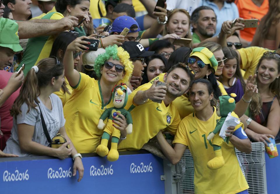  Marta poses for a selfie with fans after Brazil's defeat