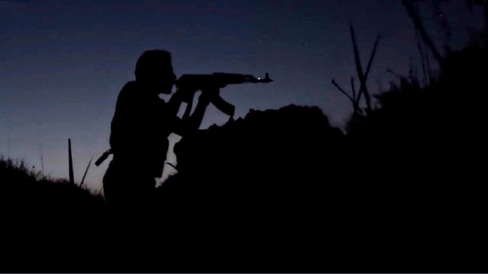  Islamic State militants silhouetted during a twilight battle along the border of Iraq and Syria