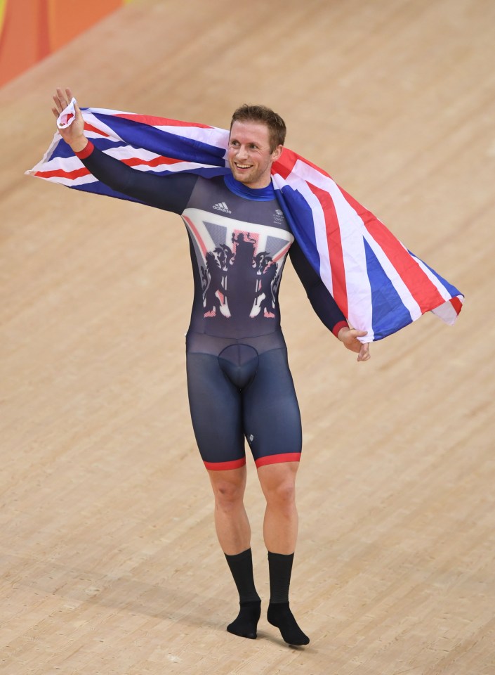  He waves the British flag for the velodrome crowd in celebration