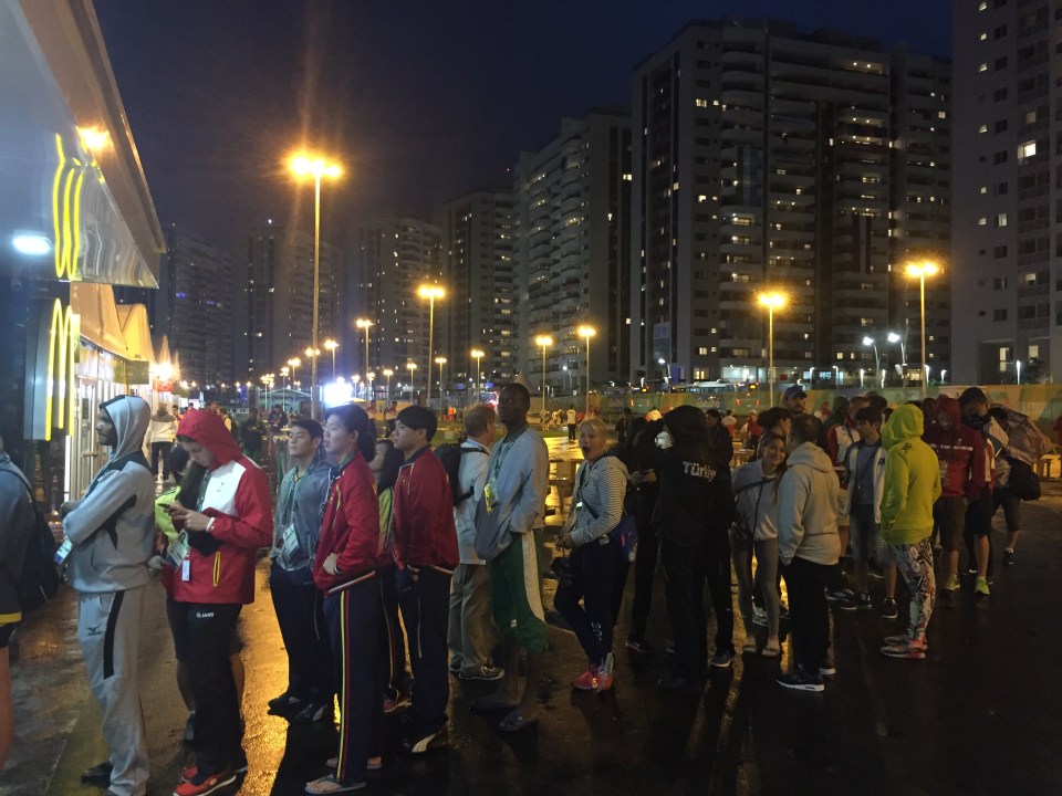  Athletes in the Olympic village queue up to order some fast food