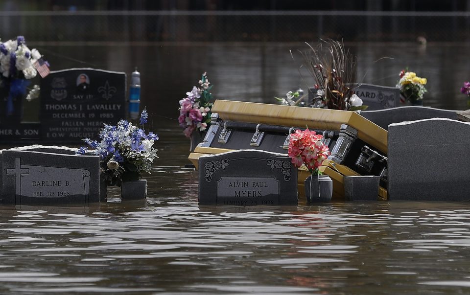  A casket is seen in a flooded cemetery