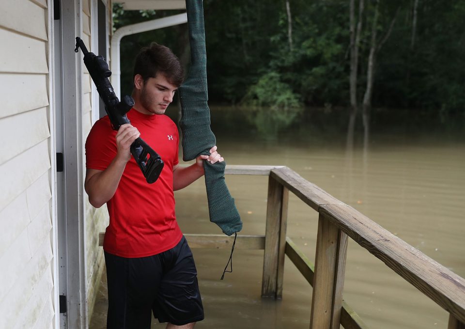  Collan Ortego salvages guns from his family's flooded home