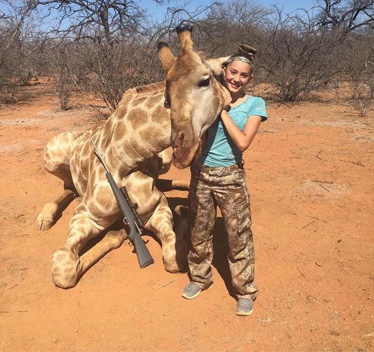  Aryanna posing with the huge giraffe she shot dead