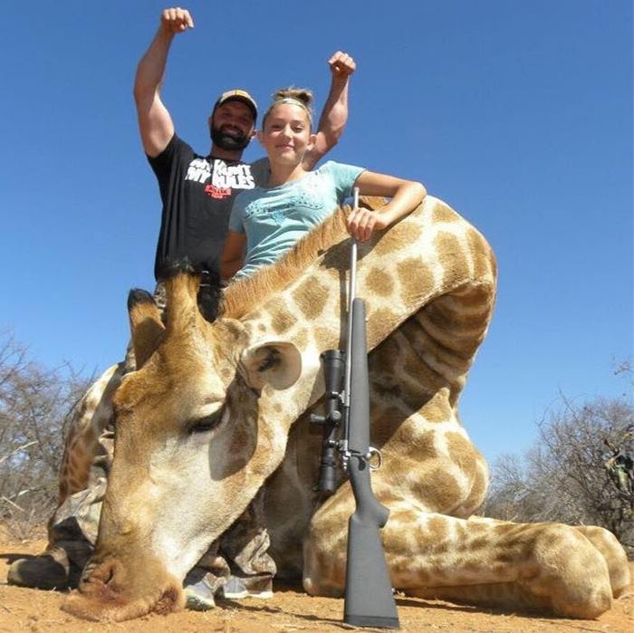  Proud dad Eli poses with his daughter and the dead giraffe