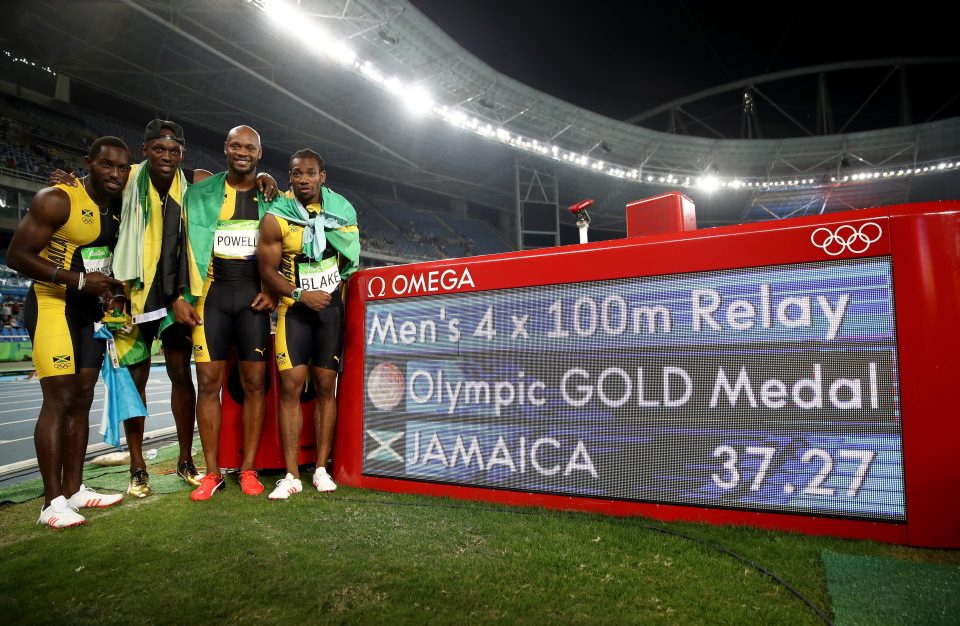  Bolt celebrates with his team-mates after another stunning performance