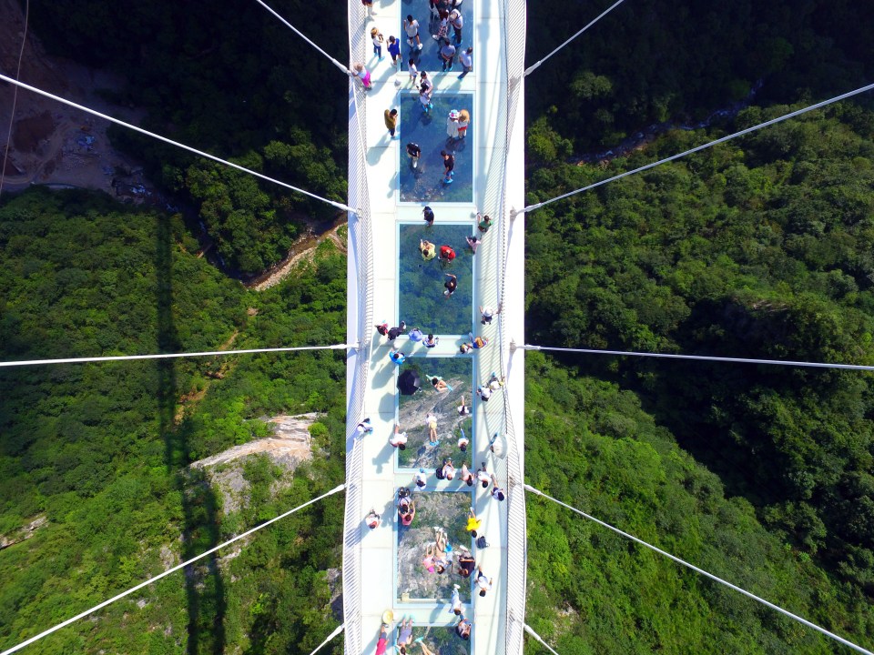  Tourists take in the view from the glass bottomed bridge