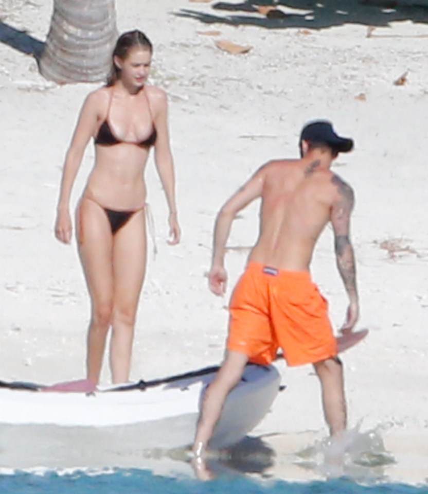  Zayn pulled the boat onto the sand as they prepared to get in