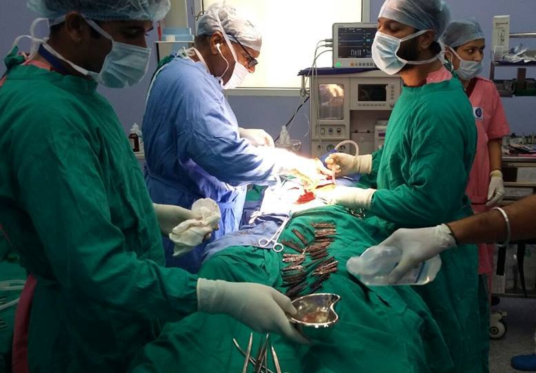  Doctors pictured removing the knives from the man's stomach