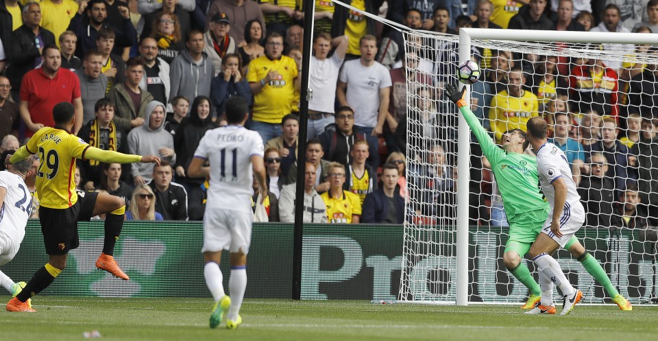  Etienne Capoue scores the opener for Watford as he crashes past Thibaut Courtois