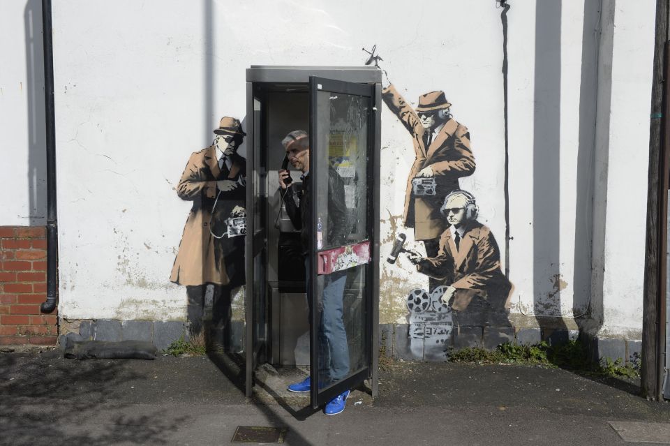  The wall used to have three spies surrounding a telephone box in Cheltenham which appeared shortly after the Edward Snowden revalations