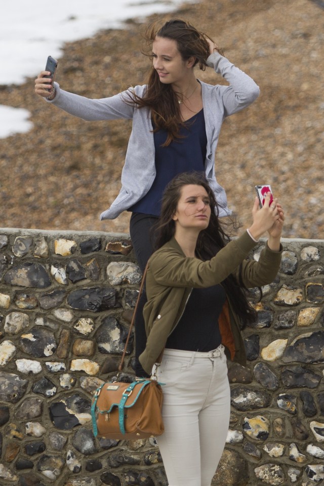  Two women spend some time on the beach in Brighton to enjoy today's sunny and warm weather