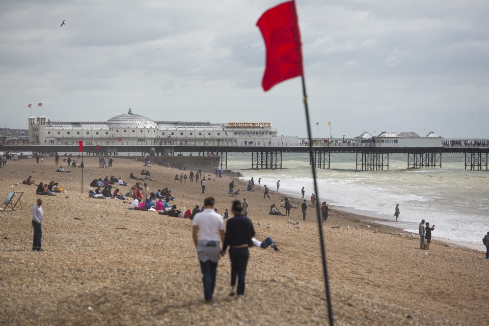  Sun-seekers flock to the beach in Brighton to take advantage of the dry weather today