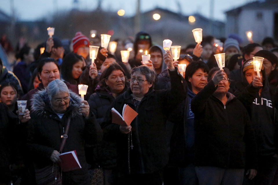  People take part in a march and candlelight vigil in the Attawapiskat