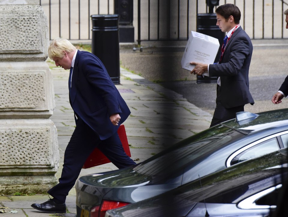  Boris Johnson arrives at work with an aide carrying a box of Three Choirs English wine