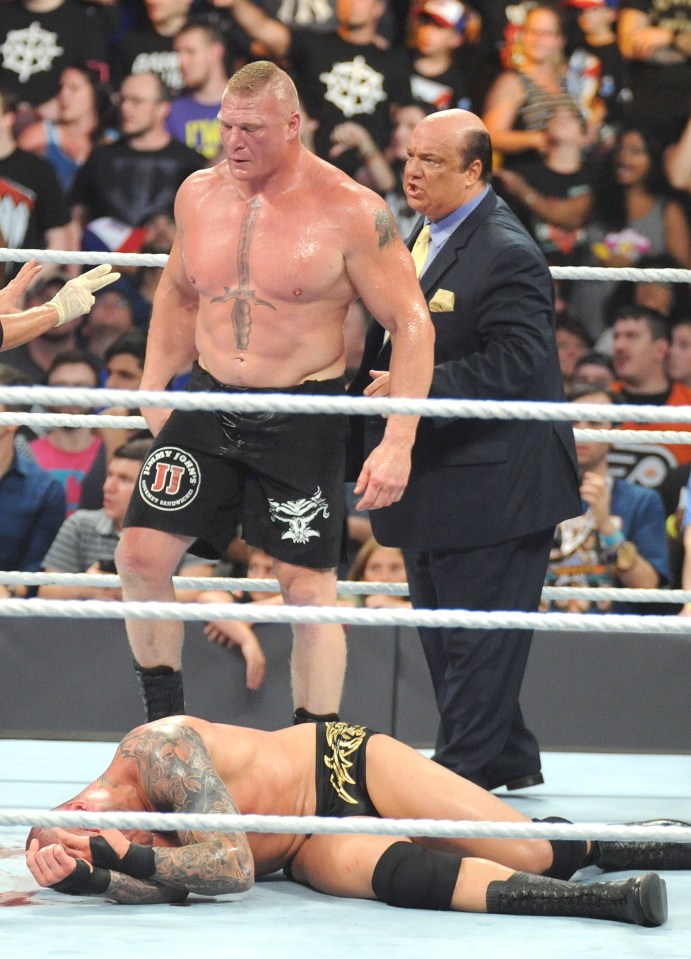  Brock Lesnar stands over Randy Orton as blood spurts from his forehead