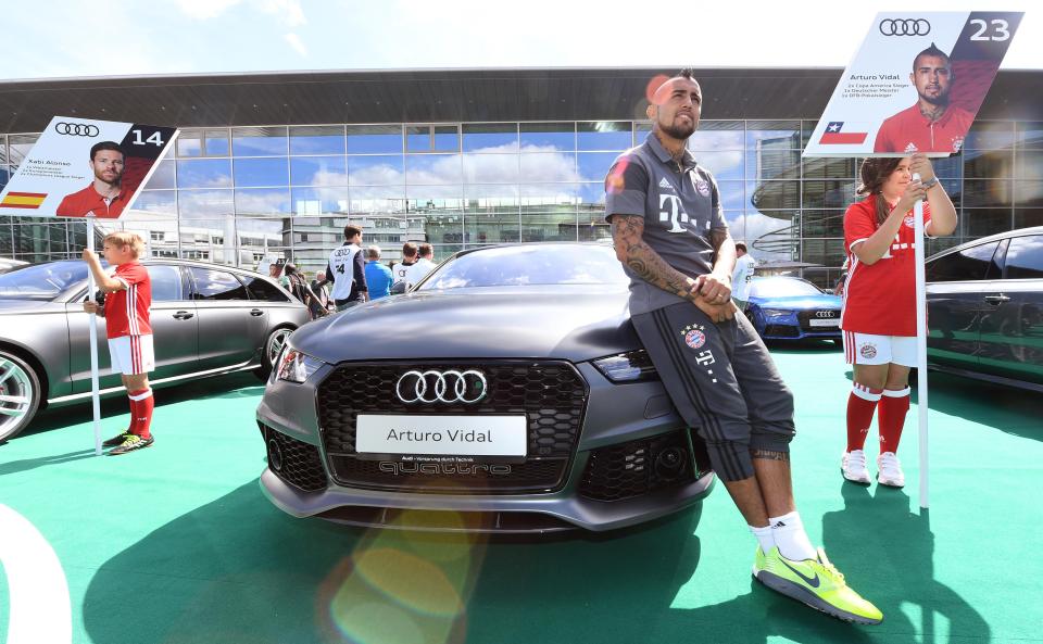  Arturo Vidal poses with his new motor given to him by the car manufacturer