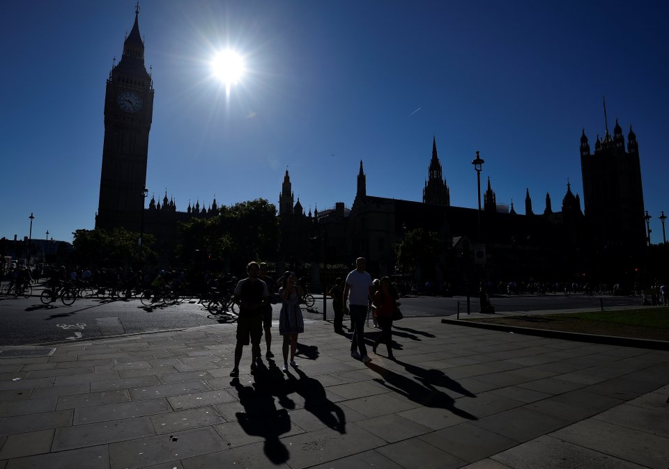  Commuters enjoy a sunny stroll to work as temperatures climb to 29C in the capital today