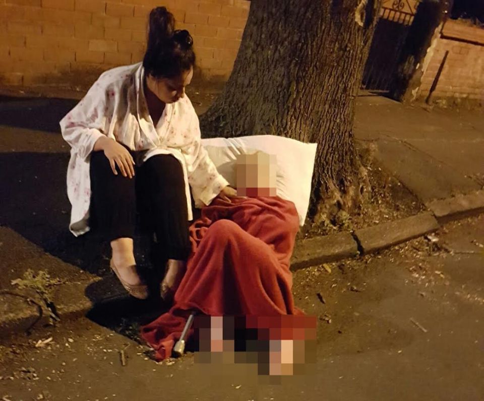  This heartbreaking picture shows the moment a frail 86-year-old woman had to wait in the street for two hours for an ambulance