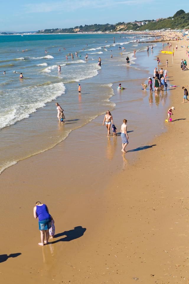  Sun-seekers enjoy the balmy 26C weather on Bournemouth beach today