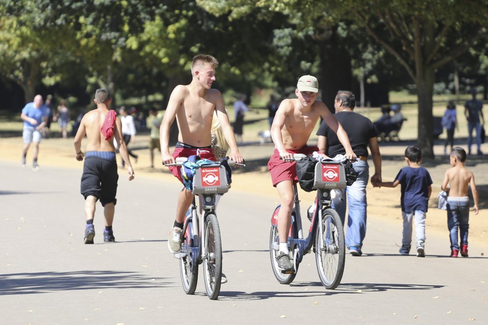  These lads cooled off by whipping their tops off as they cycled round Hyde Park