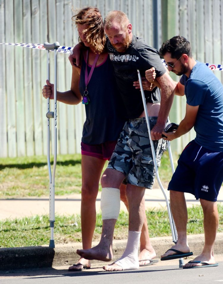  Injured Australian man Grant Scholz is helped from the scene after the knife rampage at the hostel